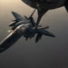A US Air Force F-15E Strike Eagle is refueled by a KC-135 Stratotanker while patrolling the skies over the Middle East.