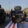 Iraq's Popular Mobilization Forces running over American flag.