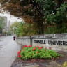 A student walks by a sign at the entrance of Cornell University in Ithaca, New York, US, October 1, 2026.