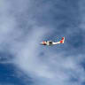 A US Coast Guard plane searches for people after it found debris from a medical transport aircraft off the shore of Massachusetts' Nantucket island, US, October 3, 2026.