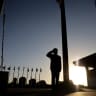 A Knesset guard lowers the Israeli flags to half-mast to commemorate the National Remembrance Day for October 7 massacre and the Iron Swords war, at the Knesset, the Israeli parliament in Jerusalem, October 27, 2024.