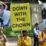 Protestors hold placards showing Britain's former Prince Andrew and late US sex offender Jeffrey Epstein during the King's Birthday Parade "Trooping the Colour" in London on June 13, 2026.