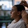 British-Israeli Emily Damari, 30, a former hostage, has her hair done during a photo shoot for her clothing brand which carries the slogan ‘never lose yourself.’