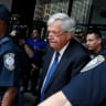 Former US House of Representatives Speaker Dennis Hastert is surrounded by officers as he leaves federal court after pleading not guilty to federal charges of trying to hide large cash transactions and lying to the FBI in Chicago, Illinois, United States, June 9, 2015.
