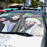 A car with a poster consisting of slain Al-Qaeda leader Osama bin Laden, late Taliban leader Mullah Omar and Afghanistan's Minister of Interior Affairs Sirajuddin Haqqani is seen during celebrations marking the fifth anniversary of the Taliban government's return to power in Kabul on August 15, 2026
