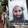 A poster of Taliban Supreme Leader Hibatullah Akhundzada is seen along a road in Kabul on August 14, 2023. (