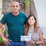 Ilan and Clara Hamami stand with a picture of their son, Asaf, who was killed on October 7, 2023.