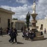 Students walk through the school of the "Our Lady of Visitation" Catholic church in the Palestinian town of Zababdeh in the northern West Bank, on April 10, 2025. 