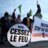 Anti-Zionist protesters hold placards that read "Gaza ceasefire" and "Macron: Stop genocide. Embargo now," during a protest in Paris, France, October 2, 2025; illustrative.