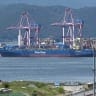 The container ship "Panstar Acro" is anchored to load containers at Busan New Port in Busan on August 22, 2026, as the vessel is scheduled to sail to Europe via the Arctic to test the commercial viability of the shipping route opened by melting ice. 