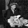 British mystery author Agatha Christie (1890-1976) autographing French editions of her books, circa 1950.