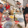CARA & TONY NACHSHON surrounded by their children at a family dinner.
