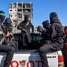 Hamas terrorists arrive to secure the area search for the last two remaining bodies of hostages - an Israeli soldier and a Thai national - from under the rubble of the Jabalia refugee camp, in the northern of Gaza Strip on December 1, 2025. as Egyptian workers accompanied by members of the ICRC 