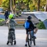 Children look at the scene of a knife attack at a vocational school in the town of Ostroleka, some 120 km north of Warsaw on October 7, 2026. Officers have arrested a 19-year-old man after eight people were wounded in a knife attack at a high school in Poland.