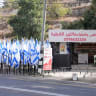 Israeli flags erected by settlers stand near a coffee shop owned by Mueyyid Hussein, which he says have obstructed the shop’s entrance and visibility, in Al-Lubban al-Sharqiya near Nablus in the West Bank, October 9, 2026. 