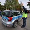 Members of the media work next to a cordoned-off area as police and fire fighters work at the site of a deadly attack at a school by a 15-year-old former pupil, in Leszczydol-Nowiny, Wyszkow County, northeast of Warsaw, Poland, October 8, 2026. 
