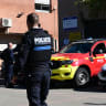 A municipal policeman speaks on the phone in front of Joseph-Lakanal middle school after a headmaster was injured by a hunting rifle shot and a teenager was arrested in Aubagne, southern France, on October 12, 2026. 