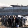 Turkish security forces line up in the buffer zone as Turkish police use water cannon to disperse Syrian supporters who gather at the border, across from the northern Syrian town of Qamishli, January 20, 2026