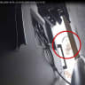 A man described as Abdulrahman Alfozan, a Saudi national employed as an OpenAI engineer, looks behind a television where a recording device had been placed at a conference room in OpenAI offices, in a still image from surveillance video included in a charging document. October 5, 2026.