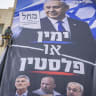 Workers hang a Likud party election campaign billboard featuring Prime Minister and Likud chairman Benjamin Netanyahu alongside opposition leaders, with the slogan “Right or Palestine,” on a building in Jerusalem, ahead of Israel’s upcoming general elections, October 14, 2026.