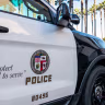 Los Angeles, USA - Close-up on the insignia and slogan of a LAPD vehicle, with the reflection of Union Station's tower visible in the car's window.