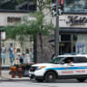 A Chicago Police officer sits in his car as he monitors the area along Michigan Avenue in Chicago, Illinois, on June 18, 2021. 