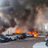 SMOKE AND FIRE rise from where a rocket fired from Gaza struck Ashkelon, on October 7, 2023.