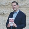 Author Gil Hoffman stands with his new book, ‘The Blood Libel Machine,’ which argues that the spread of anti-Israel narratives and the surge in global antisemitism were the result of a premeditated information campaign that had been in the works for decades. 