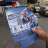 A man hands out Likud campaign leaflets featuring Prime Minister Benjamin Netanyahu, in Jerusalem's Mahane Yehuda market, October 16, 2026