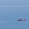 A U.S. Coast Guard Helicopter flies over the Pacific Ocean on August 21, 2026 in Malibu, California.
