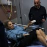 American freelance photojournalist Heidi Levine lies on a gurney in the emergency room of a hospital in Ramallah, as she is treated after allegedly being attacked by Israeli settlers while photographing farmers harvesting their olives, in the Palestinian village of Abu Falah on October 16, 2026.