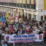 Participants hold signs and flags as thousands march at CGTP-IN decentralized national demonstration to demand higher wages, better pensions, and improved public services from Cais do Sodré to Rossio on October 17, 2026 in Lisbon, Portugal.