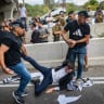 Ultra-Orthodox Jewish men clash with police officers and civilians as they block a road during a protest against the jailing of yeshiva students who failed to comply with an army recruitment order, at the Yavne Interchange on Route 4, October 18, 2026.