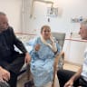 Democrats MK Gilad Kariv (L) and party leader Yair Golan (R) meet with Washington Post photojournalist Heidi Levine in the hospital on October 18, 2026