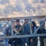 Israeli military forces fire tear gas and disperse Palestinian farmers, preventing them from continuing the olive harvest as they attempt to cross an iron gate erected by the Israeli army in the village of Salem, east of Nablus in the West Bank, October 17, 2026.