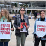 Israelis hold signs during a silent protest calling for justice for Shoshana Strock, who was found dead in her apartment last night after claiming she had been sexually abused over the years, at Habima Square in Tel Aviv, March 15, 2026.