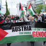  Participants waving Palestinian flags walk behind a banner reading "Austria you enable genocide" during a pro-Palestinian demonstration under the motto 'Song Protest Vienna 2026 - No Stage for Genocide' against Israel's participation in Eurovision in Vienna, Austria, on May 16, 2026.  