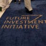 Guests attends walk along a carpect embossed with the logo of the Future Investment Initiative (FII), on the first day of the conference in Riyadh on October 28, 2025. (Illustrative)