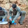 A weapon is found, being examined by police.