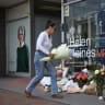 A woman leaves flowers outside the electoral office of independent Australian lawmaker Helen Haines Tuesday, 20th October 2026