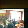 A screen set up at a hall of the Moscow City Court broadcasts the verdict announcement in the trial of US citizen Stephen Hubbard, then 72, accused of fighting as a mercenary for Ukraine, in Moscow on October 7, 2024.