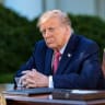 US President Donald Trump listens as first lady Melania Trump delivers remarks as he prepares to sign an executive order in the Rose Garden of the White House on October 19, 2026 in Washington, DC.