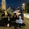 Ultra-Orthodox Jewish men block a road and clash with police during a protest against the jailing of yeshiva students who failed to comply with Israeli military draft orders, in Jerusalem, August 2, 2026.