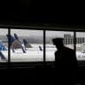  A pilot walks by United Airlines planes as they sit parked at gates at San Francisco International Airport.