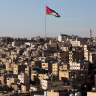 A Jordanian flag flies over the capital city, Amman, Jordan August 17, 2025.