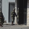Israeli soldiers move near a building in Hebron, West Bank on October 23, 2026. 