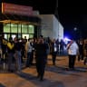 People and police gather outside of Al-Karak Government Hospital, where some of the injured are receiving treatment after gunmen opened fire during a funeral at Hamoud Church, in Karak, Jordan, October 23, 2026.