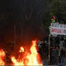 A fire burns next to a sign reading "Inequality of opportunity" during an authorised demonstration organised by a labour union in Marseille, France, October 24, 2026