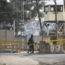 Israeli soldiers guard a closed checkpoint south of the West Bank city of Nablus, following the Israeli army’s decision to impose a widespread closure across the West Bank after a deadly shooting attack near Hebron yesterday, which killed two Israeli soldiers, October 24, 2026.