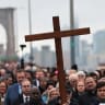 Worshippers walk to a station during the Way of the Cross procession over the Brooklyn Bridge on April 03, 2026 in New York City. 